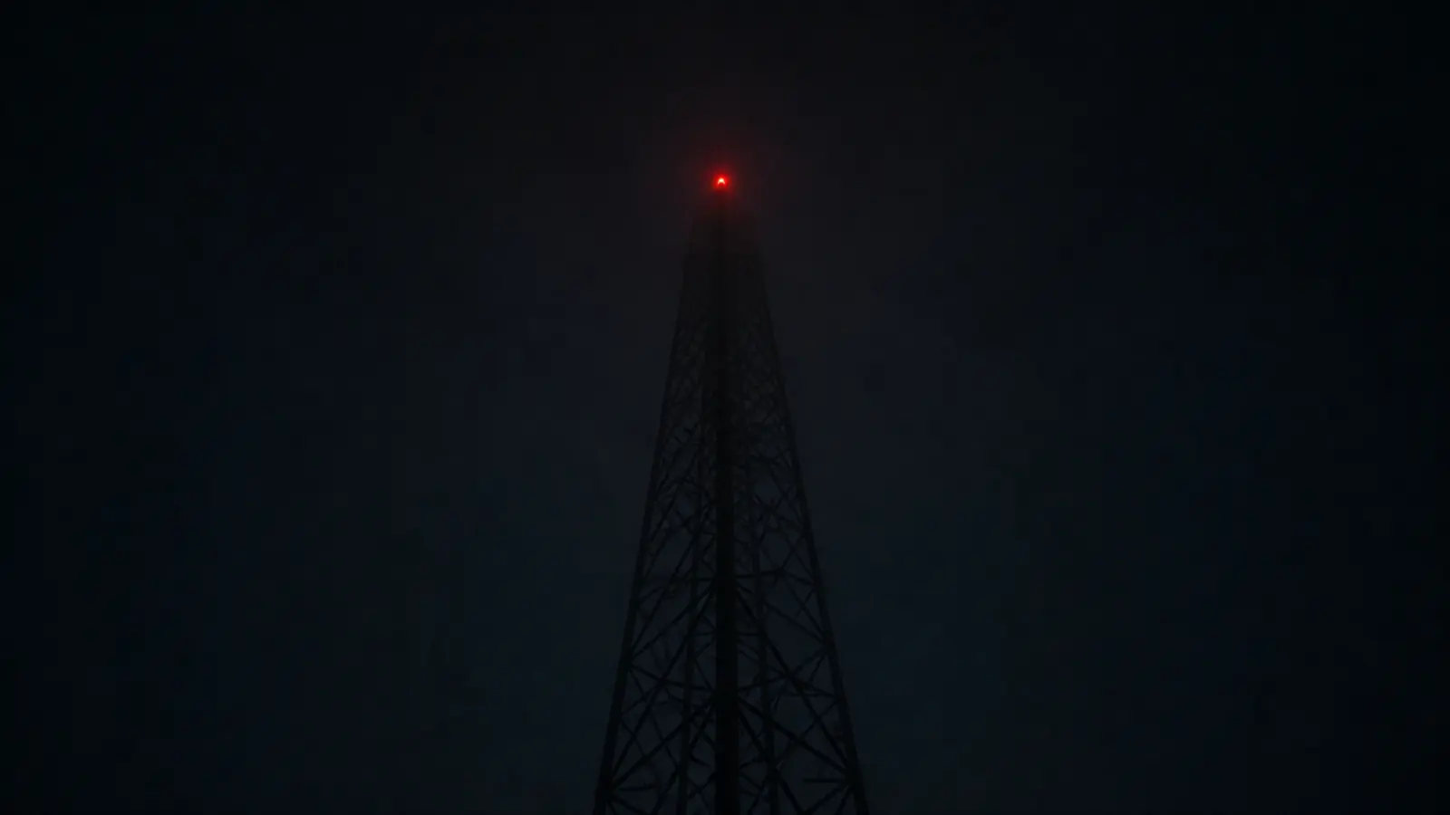A communications mast in fog.